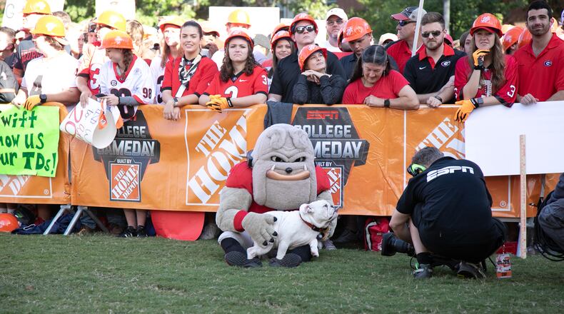 'Kirby,' a 6-month-old English bulldog puppy, snuggles with his new best friend, UGA mascot Hairy Dawg, at the ESPN College Game Day setup this past Saturday on UGA's Myers Quad.