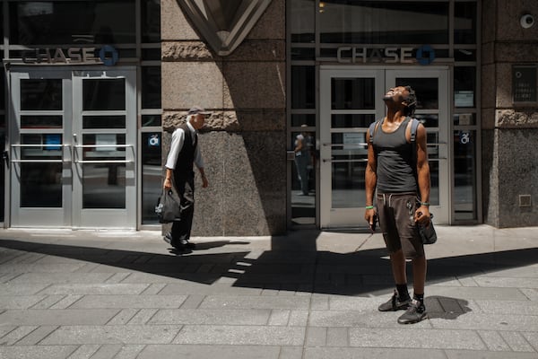 A man squints at the sun during a heatwave on Tuesday, June 24, 2025, in New York. (AP Photo/Olga Fedorova)
