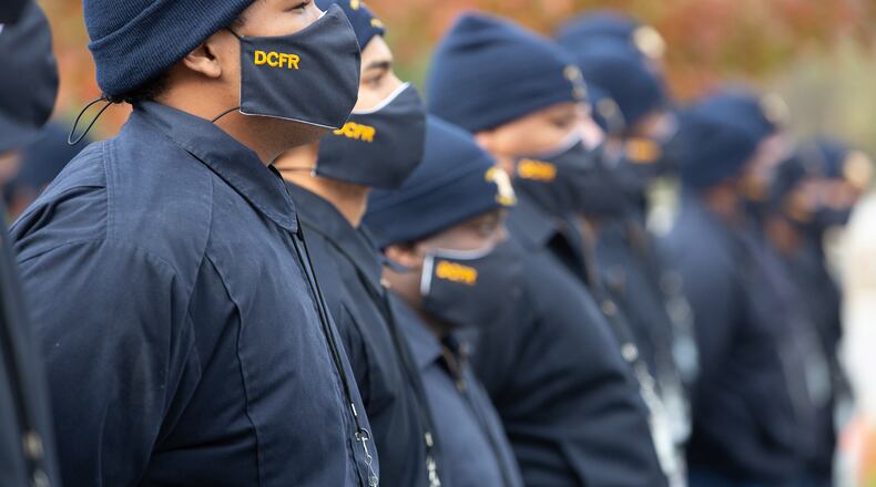 DeKalb Academy Recruits listen to the speakers at a ceremony before they start to hand out some of the 10,000 COVID-19 care kits at a Lithonia Walmart on November 25, 2020. STEVE SCHAEFER / SPECIAL TO THE AJC