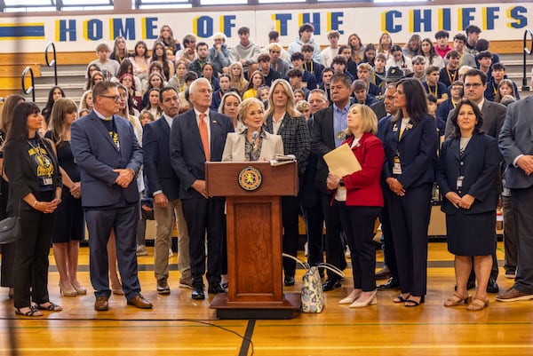 U.S. Secretary of Education Linda McMahon, center, joined by local elected officials speaks during a visit to Massapequa High School, Friday, May 30, 2025, in Massapequa, N.Y. (Alejandra Villa Loarca/Newsday via AP)