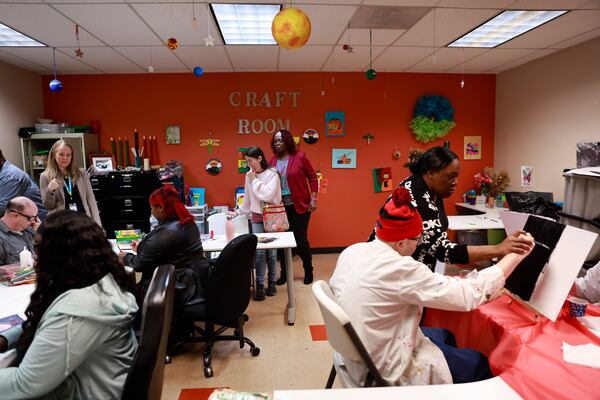 Adults create art while attending InCommunity’s Art & Food Day program in Marietta on Wednesday, Jan. 21, 2026.  The organization serves individuals with intellectual and developmental disabilities. (Natrice Miller/AJC)