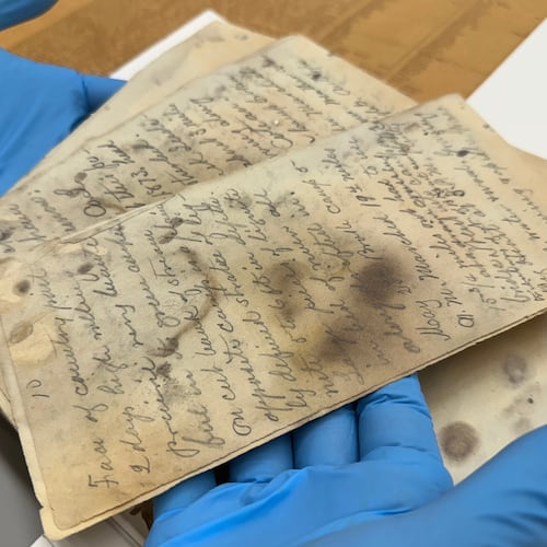 State Historical Society of North Dakota Deputy State Archivist Lindsay Meidinger holds pages of the diary of Mark Kellogg, a reporter killed during the Battle of the Little Bighorn in 1876, at the North Dakota Heritage Center and State Museum in Bismarck, N.D., Wednesday, June 24, 2026. (AP Photo/Jack Dura