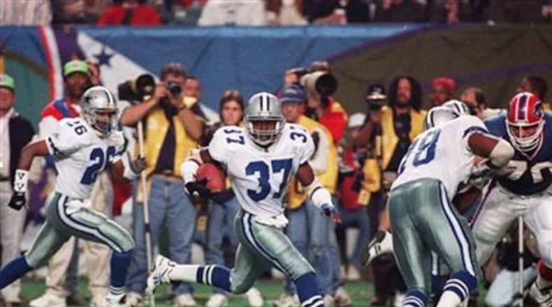 FILE - In this Jan. 30, 1994 file photo, Dallas Cowboys safety James Washington (37) sprints to a touchdown after Buffalo Bills Thurman Thomas fumbled the ball during third quarter action at Super Bowl XXVIII in the Georgia Dome in Atlanta. Washington recovered the fumble and ran 46 yards for the tying touchdown in the second half. (AP Photo/Doug Mills, File)