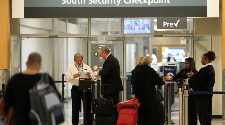 Passengers go to the South Security Checkpoint at Hartsfield-Jackson International Airport.