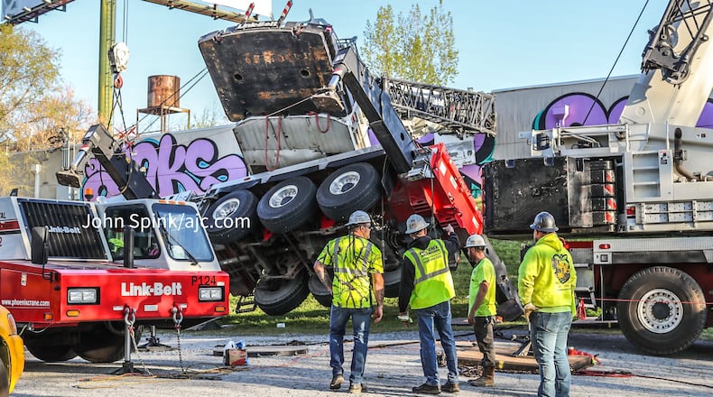 The crane fell onto a business while trying to remove an HVAC unit from a roof.