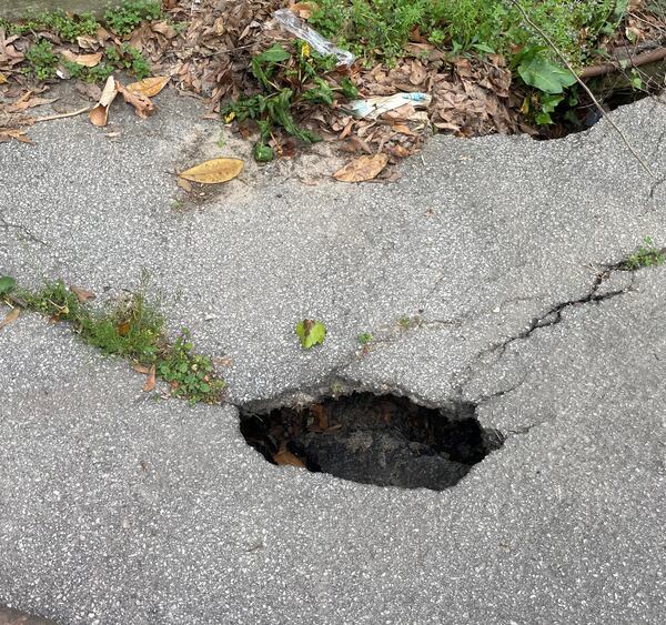 This shows the damage in March 2022. May says the damage has gotten worse, as it is now a hole on the road.