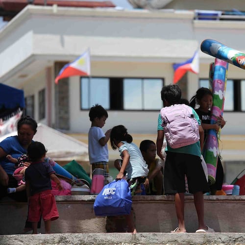 Residents take shelter in a field at a municipal hall in Sarangani province, Philippines, Wednesday, June 10, 2026. (AP Photo/Basilio Sepe)