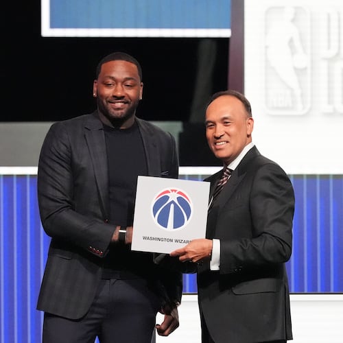 Washington Wizards' John Wall, left, and NBA Deputy Commissioner Mark Tatum, pose for photos after Tatum announced that the Wizards had won the first pick in the NBA basketball draft lottery in Chicago, Sunday, May 10, 2026. (AP Photo/Nam Y. Huh)