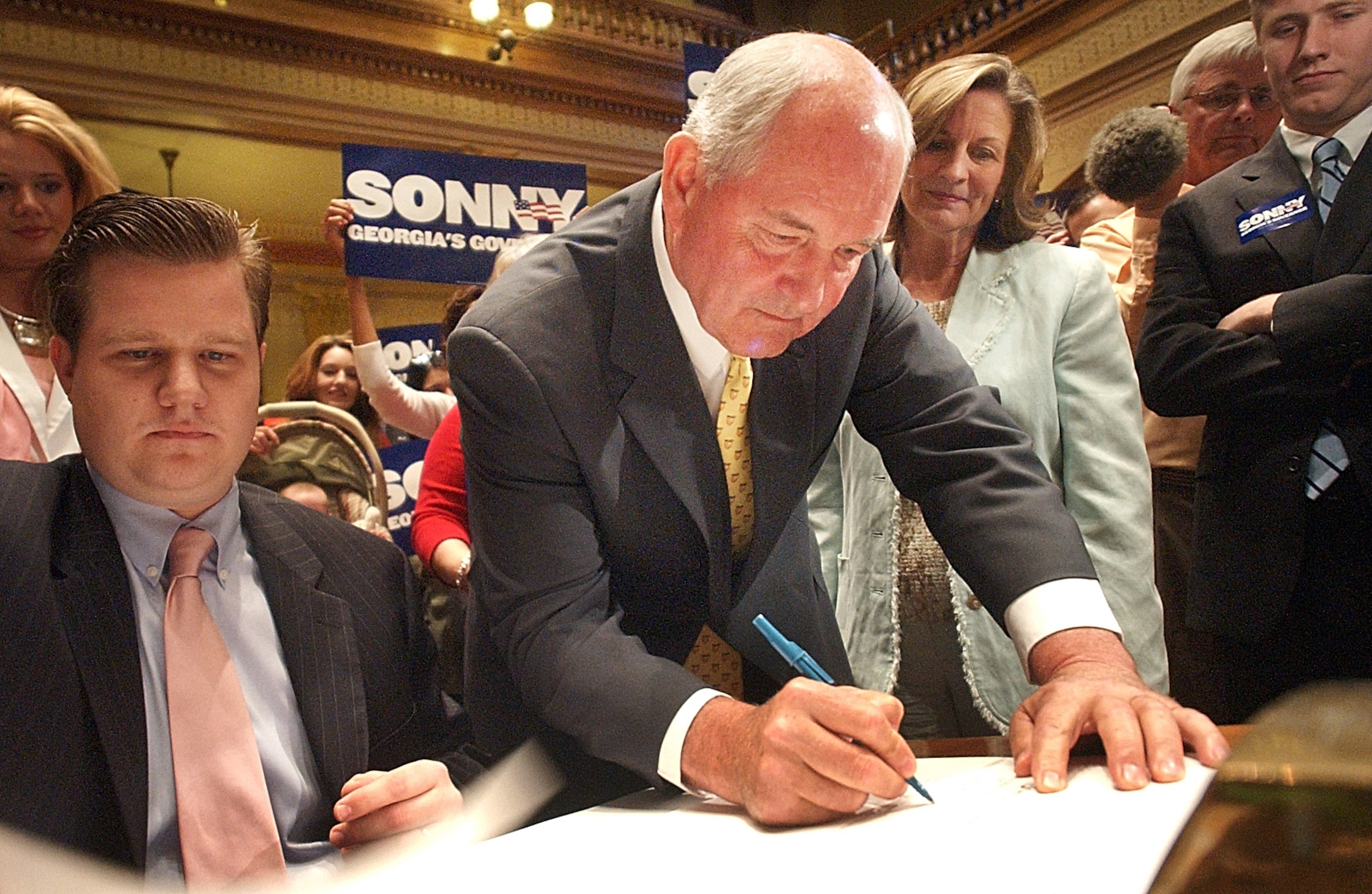 Gov. Sonny Perdue (with pen) in the Senate chambers at the Capitol in Atlanta in 2006.