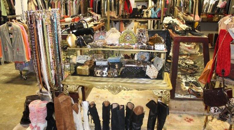 December 2, 2016 Atlanta - Christy Ogletree Ahlers, owner of Peachtree Battle Estate Sales and Liquidations, prepares for the estate sale of Diane McIver’s wardrobe next week as she is surrounded by more than 2,000 of Diane McIver’s clothing and jewelry items in a warehouse showroom at Peachtree Battle Estate Sales and Liquidations on Friday, December 2, 2016. More than 2000 of her articles of clothing, jewelry, hats and shoes are on display in his warehouse showroom. Tex McIver has enlisted an estate liquidation company to sell more than 2,000 of his deceased wife’s clothing and jewelry items. HYOSUB SHIN / HSHIN@AJC.COM