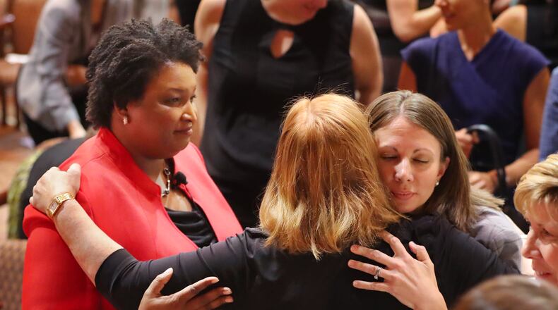 Democratic candidates for governor Stacey Abrams (left) and Stacey Evans (right) greet supporters after their first forum last October. Curtis Compton/ccompton@ajc.com