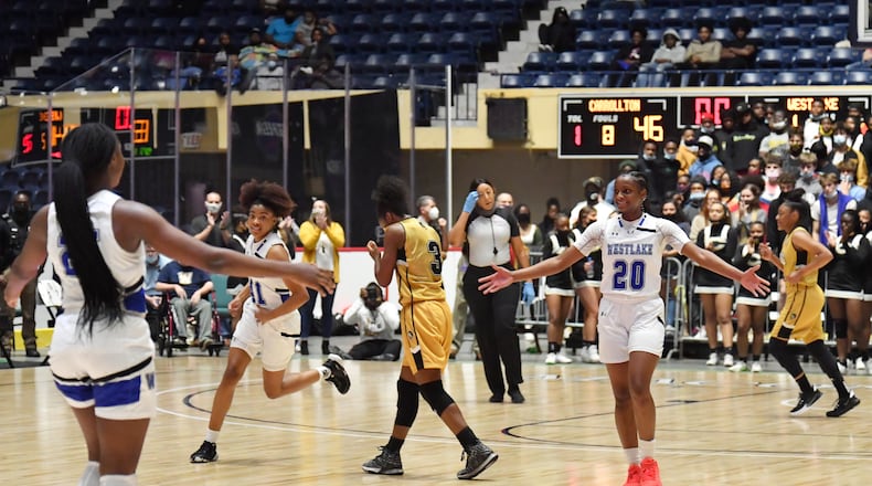 Westlake players celebrate their 64-46 victory over Carrollton in the girls 6A state title game in Macon.