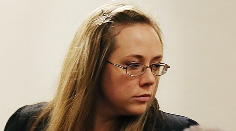 Leanna Harris, right, wife of Justin Ross Harris, the father of a toddler who died after police say he was left in a hot car for about seven hours, arrives for her husband's bond hearing in Cobb County Magistrate Court, Thursday, July 3, 2014, in Marietta, Ga. Harris who police say intentionally killed his toddler son by leaving the boy inside a hot SUV was exchanging nude photos with women the day his son died and had looked at websites that advocated against having children, a detective testified Thursday. At that same hearing, a judge refused to grant bond for Harris, meaning he will remain in jail. (AP Photo/Marietta Daily Journal, Kelly J. Huff, Pool)