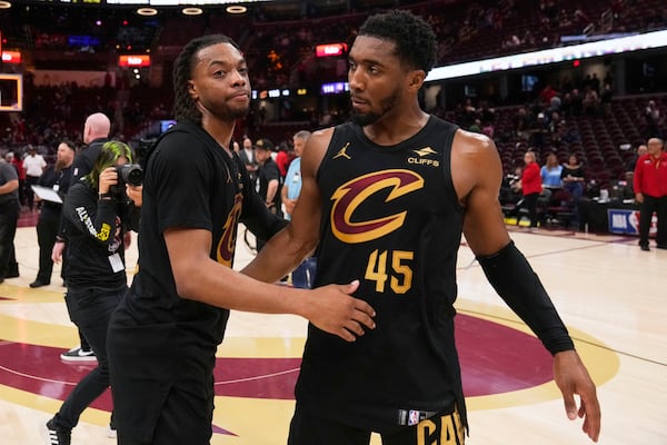 Cleveland Cavaliers guard Darius Garland, left, and guard Donovan Mitchell hug each other after the Indiana Pacers defeated the Cavaliers 114-105 in Game 5 of an Eastern Conference semifinal NBA basketball playoff Tuesday, May 13, 2025, in Cleveland. (AP Photo/Sue Ogrocki)