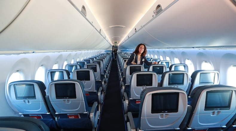 A Delta employee checks out the interior during the unveiling of the new A220 aircraft while celebrating the 10-year anniversary of merging with Northwest at the Delta Air Lines TechOps on Monday, Oct 29, 2018, in Atlanta. Curtis Compton/ccompton@ajc.com