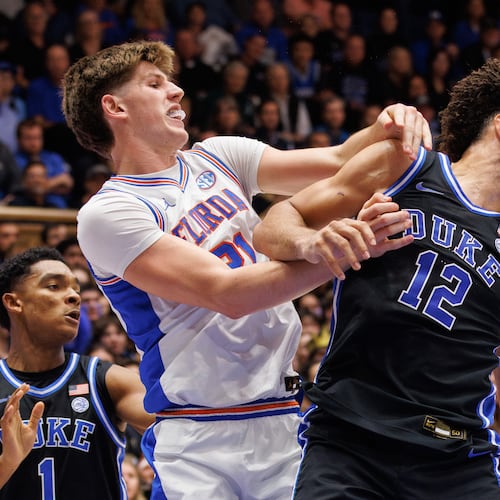 Duke's Cameron Boozer (12) and Floida's Alex Condon (21) battle for a loose ball during the first half of an NCAA college basketball game in Durham, N.C., Tuesday, Dec. 2, 2025. (AP Photo/Ben McKeown)