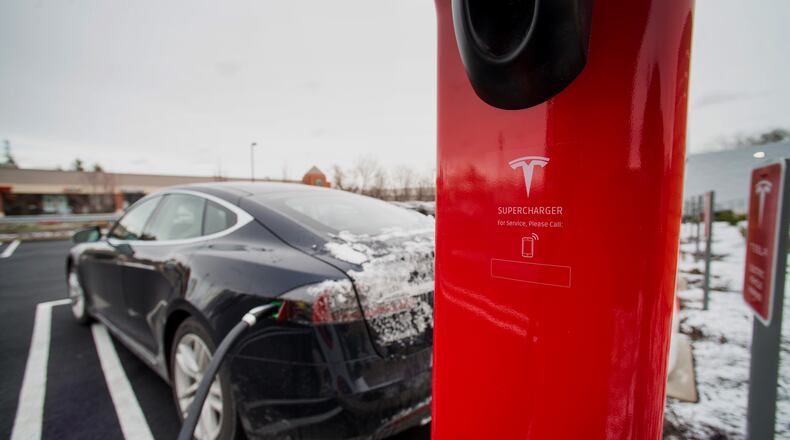 A Model S electric vehicle (EV) charges at a supercharger station at the Tesla Motors Inc. Gallery and Service Center in Paramus, New Jersey, U.S., on Thursday, Dec. 11, 2014. Tesla rose 1.2 percent at the end of trading mid last week to close at $216.89 after falling as low as $204.27. For the year, the shares have gained 44 percent. Photographer: Ron Antonelli/Bloomberg A Model S electric vehicle (EV) charges at a supercharger station at the Tesla Motors Inc. Gallery and Service Center in Paramus, New Jersey. Ron Antonelli/Bloomberg