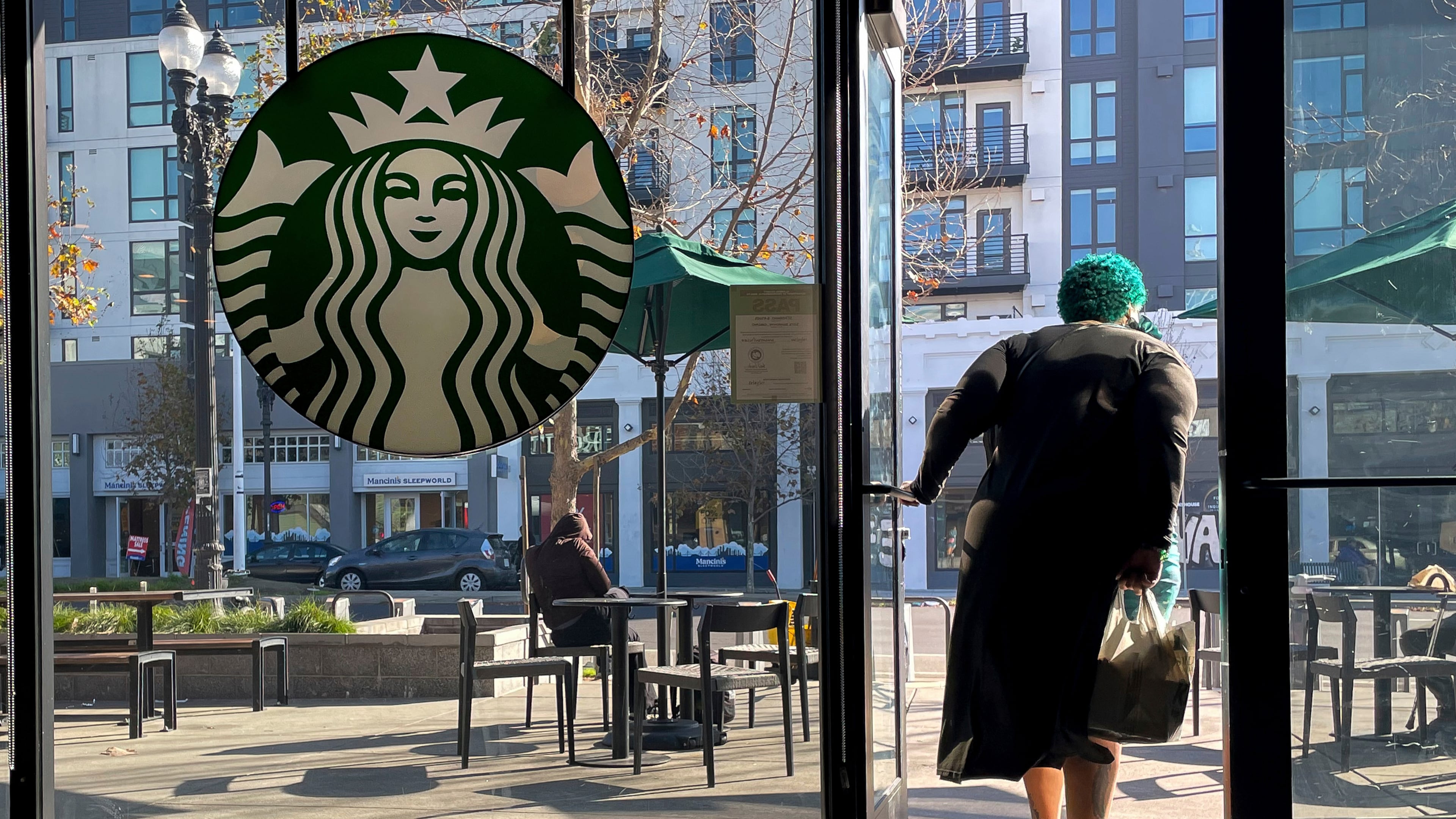 FILE - A costumer exits a Starbucks store in Oakland, Calif., Thursday, Jan. 16, 2025. (AP Photo/Godofredo A. Vásquez, File)