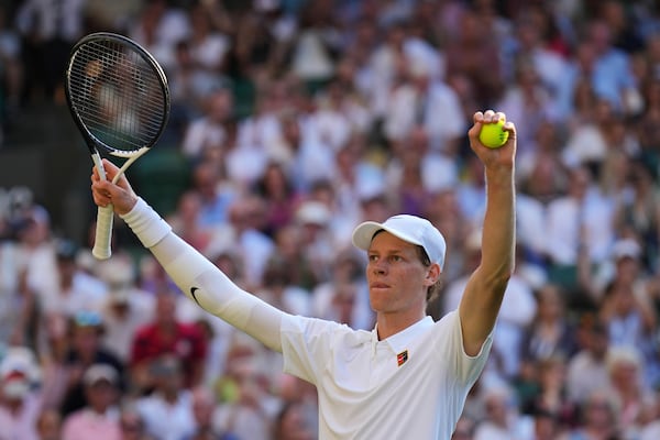 Italy's Jannik Sinner celebrates after beating Serbia's Novak Djokovic in a men's singles semifinal at the Wimbledon Tennis Championships in London, Friday, July 11, 2025. (AP Photo/Kin Cheung)