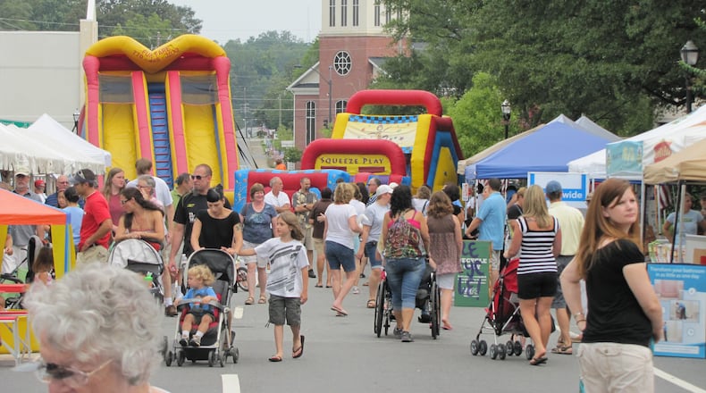 Visitors peruse antiques and handcrafted arts around the Historic Marietta Square for Marietta StreetFest.