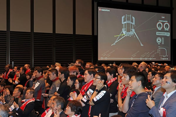 People await the update on ispace's private lunar lander’s attempt to touch down on the moon Friday, June 6, 2025, in Tokyo, Japan. (Kyodo News via AP)