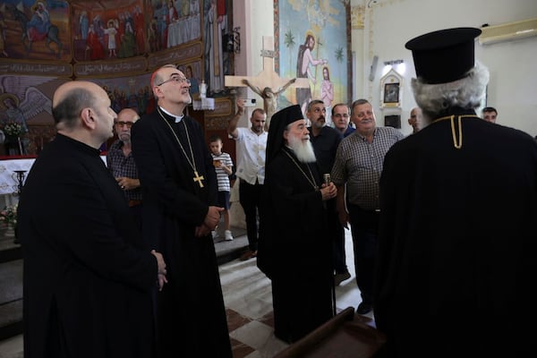 Patriarchs from Jerusalem, Latin Patriarch Cardinal Pierbattista Pizzaballa, second left, and Greek Orthodox Patriarch Theophilos III, center, lead a religious delegation to the Gaza Strip at the Holy Family Catholic Church, struck by an Israeli shell the day before in Deir al-Balah, Friday, July 18, 2025. (Latin Patriarchate of Jerusalem via AP)