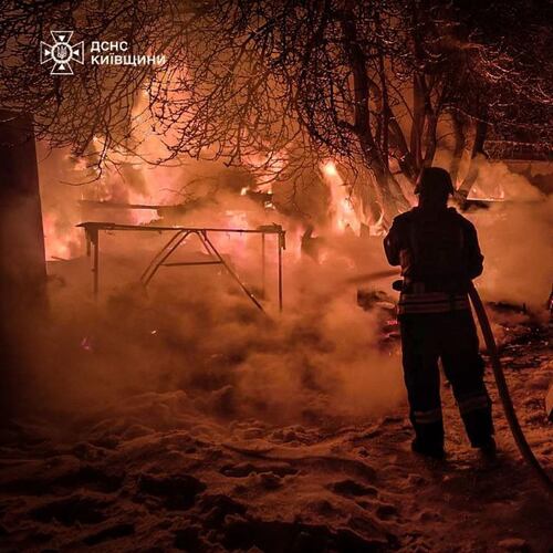 In this photo provided by the Ukrainian Emergency Service, emergency services personnel work to extinguish a fire following a Russian attack in Kyiv region, Ukraine, Tuesday, Jan. 13, 2026. (Ukrainian Emergency Service via AP)