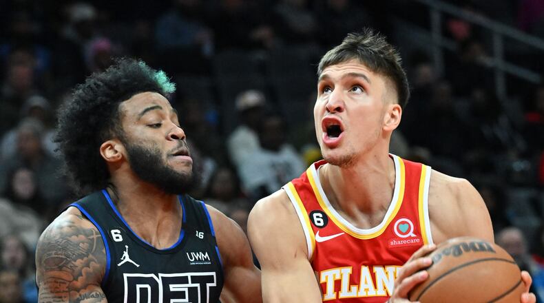 Hawks guard Bogdan Bogdanovic (13) dribbles against Pistons forward Saddiq Bey during the first half of Friday's game at State Farm Arena. (Hyosub Shin / Hyosub.Shin@ajc.com)