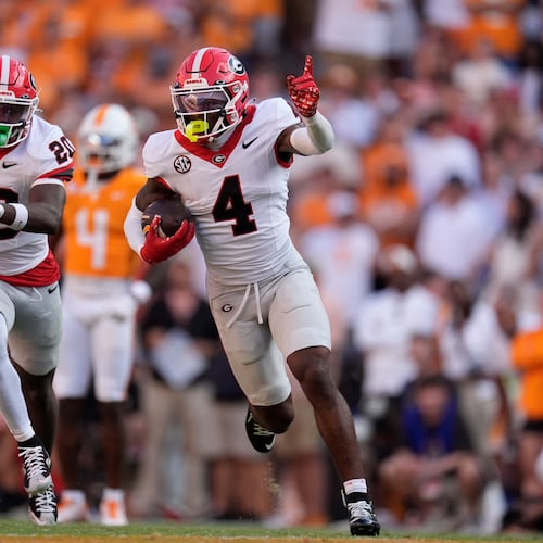 FILE - Georgia defensive back KJ Bolden (4) celebrates an interception with teammate JaCorey Thomas (20) during the second half of an NCAA college football game against Tennessee, Sept. 13, 2025, in Knoxville, Tenn. (AP Photo/George Walker IV, File)