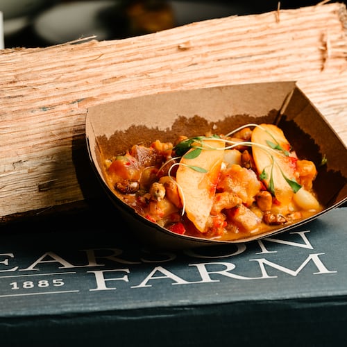 A cardboard plate holds a dish that highlights peaches during Peachfest. It's sitting on top of a Pearson Farm box.