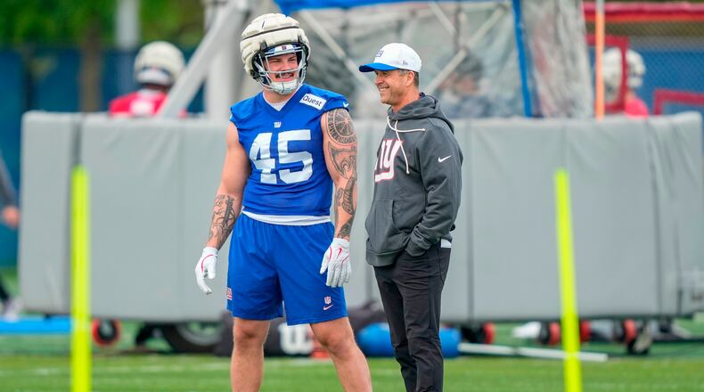 New York Giants head coach John Harbaugh, right, talks with New York Giants fullback Grant Finley, left, (45) at rookie minicamp at the NFL football team's practice facility, Saturday, May 9, 2026, in East Rutherford, N.J. (AP Photo/Yuki Iwamura)