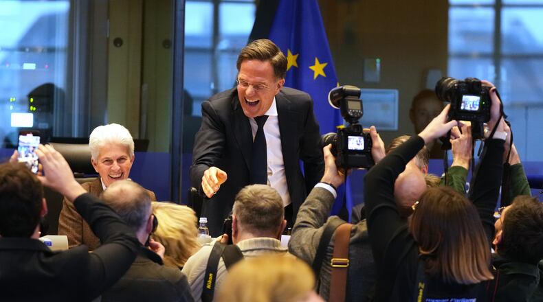 NATO Secretary General Mark Rutte, center, greets the audience prior to his address during the Security and Defence Committee at the European Parliament in Brussels, Monday, Jan. 26, 2026. (AP Photo/Virginia Mayo)