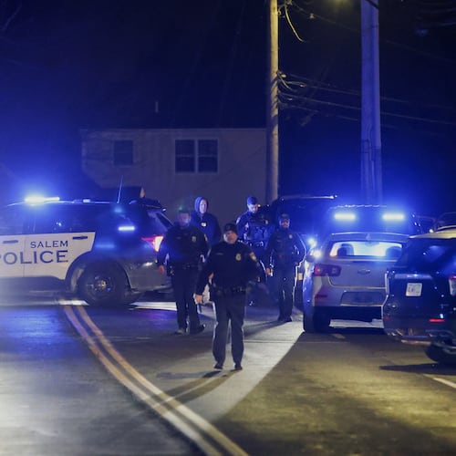 Law enforcement officers search the area for the Brown University shooting suspect, Thursday, Dec. 18, 2025, in Salem, N.H. (AP Photo/Reba Saldanha)