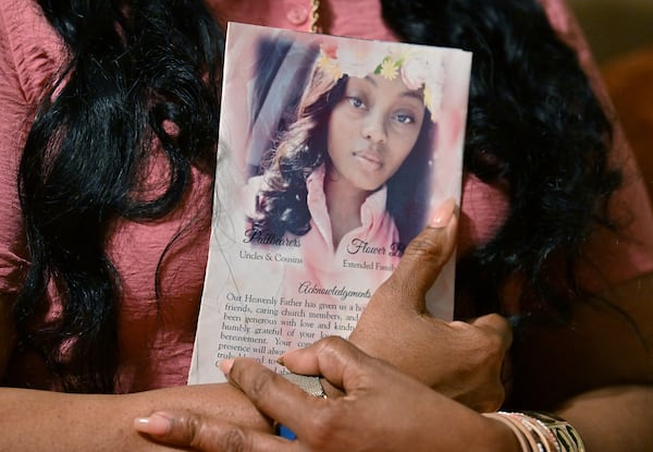 Shanette Williams, whose daughter Amber Nicole Thurman died after a delay in emergency medical care tied to Georgia’s abortion ban, holds a funeral service program at her home on Wednesday, April 29, 2026, in Covington. (Hyosub Shin/AJC)