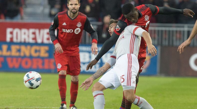 Toronto FC's Chris Mavinga (23) beats Atlanta United forward Hector Villalba (15) to the ball during the first half of an MLS soccer match Saturday, April 8, 2017, in Toronto. (Chris Young/The Canadian Press via AP)
