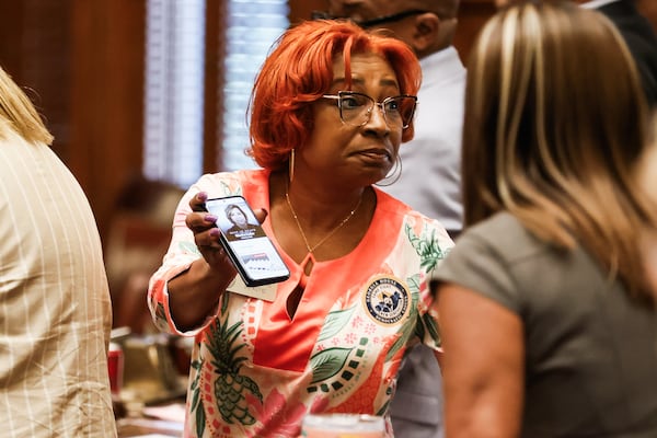 Rep. Rhonda Taylor shows fellow representatives an article about the death of columninst Martha Zoller on the House floor as the state legislature convenes for the fourth day of a special legislative session at the Capitol in Atlanta on Monday, June 22, 2026. (Abbey Cutrer/AJC)