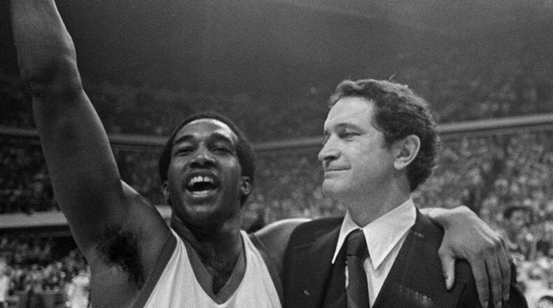 Marquette's Butch Lee (left) and his coach Al McGuire smile after the Marquette beat UNCC 51-49 in the NCAA semifinals on this March 26, 1977 in Atlanta.