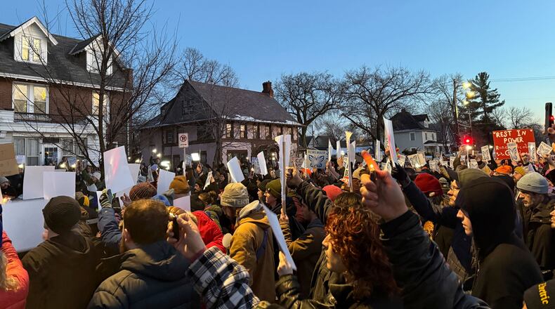 Demonstrators gather during a vigil near where an Immigration and Customs Enforcement officer shot and killed a woman in Minneapolis, Wednesday, Jan. 7, 2026. (AP Photo/Giovanna Dell'Orto)