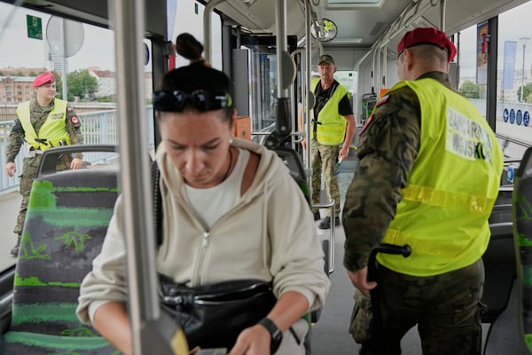 Polish border police check passengers on a bus at a checkpoint bordering Germany, in Slubice, Poland, Monday, July 7, 2025. (AP Photo/Ebrahim Noroozi)