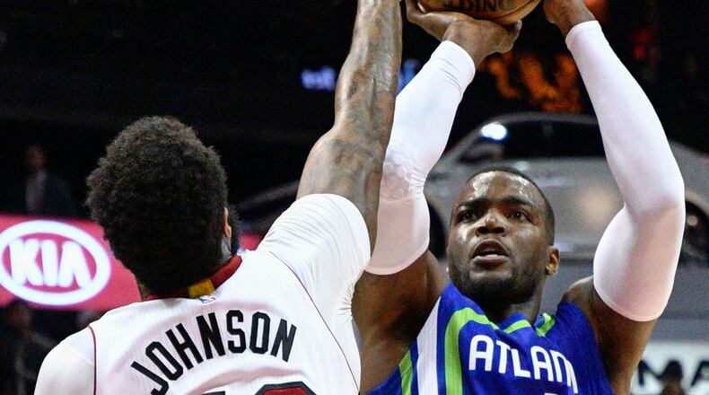 Atlanta Hawks forward Paul Millsap shoots as Miami Heat forward James Johnson defends during the first half of an NBA basketball game, Friday, Feb. 24, 2017, in Atlanta. (AP Photo/John Amis)