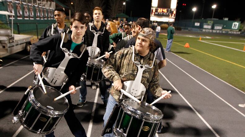 In this 2015 file photo, Roswell Hornets drummers pump up the crowd before their playoff game against  Collins Hill at Roswell High School Stadium.