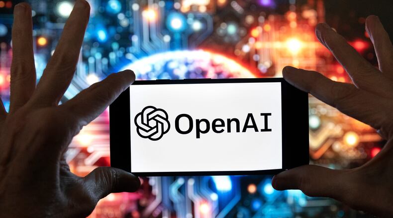 FILE - The OpenAI logo is displayed on a cell phone in front of an image generated by ChatGPT's Dall-E text-to-image model, Dec. 8, 2023, in Boston. (AP Photo/Michael Dwyer, File)