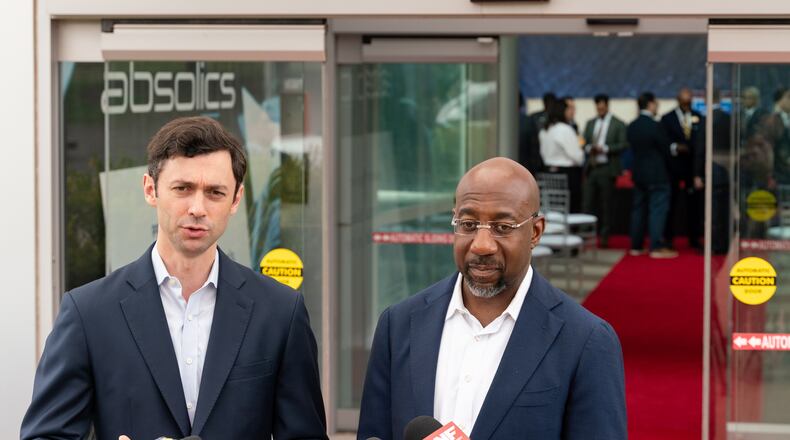 U.S. Sens. Jon Ossoff, left, and Raphael Warnock, both Democrats from Georgia, on Nov. 7 in Covington, Georgia. (Ben Hendren/The Atlanta Journal-Constitution)