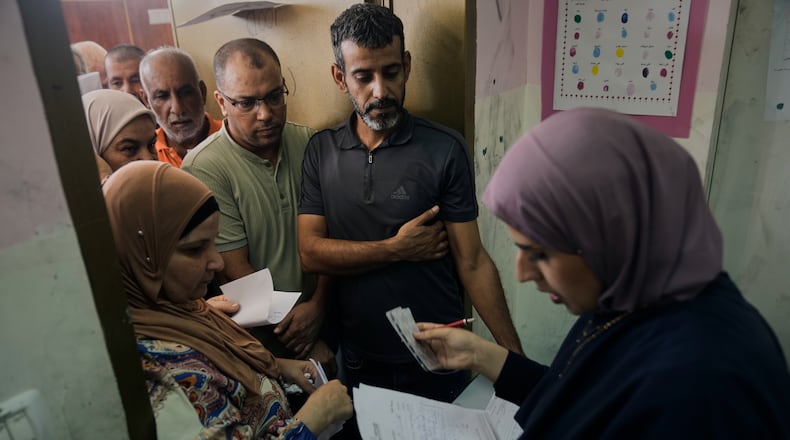 Palestinian patients line up for treatment at a mobile health clinic operated by Physicians for Human Rights Israel (PHRI) in the West Bank town of Iktaba, Tuesday, Aug. 4, 2026. (AP Photo/Majdi Mohammed)