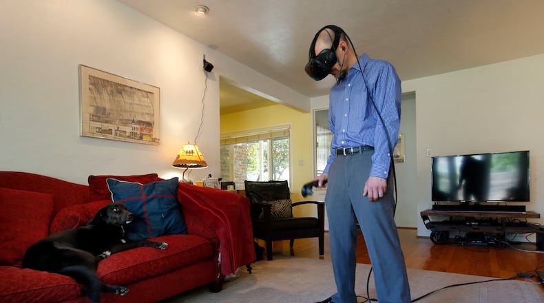 Troy Wolverton, technology reporter for the Bay Area News Group, tests HTC's new virtual reality headset, the Vive, at his home in San Jose, Calif., on Monday, April 4, 2016. (Karl Mondon/Bay Area News Group/TNS)