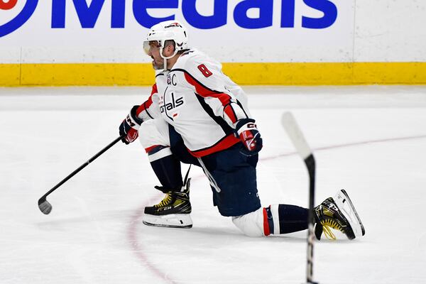 Washington Capitals' Alex Ovechkin (8) celebrates his 889th NHL goal against the Winnipeg Jets during the third period of their NHL hockey game in Winnipeg, Manitoba, Tuesday, March 25, 2025. (Fred Greenslade/The Canadian Press via AP)