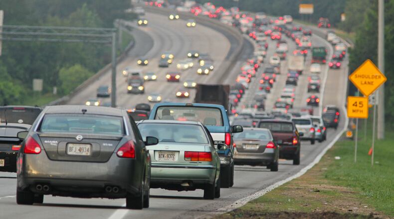 Cars begin to enter the shoulder on southbound Ga. 400 at Holcomb Bridge Road on May 14, 2012.