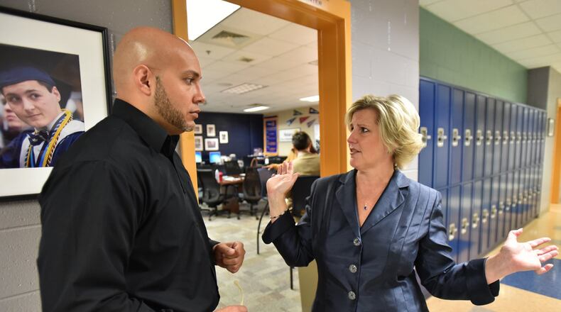 April 20, 2017 Marietta - Leigh Colburn (right), director of the Graduate Marietta Student Success Center, talks to Jose Mena, student behavior program specialist from Fulton County Schools, at the Graduate Marietta Student Success Center in Marietta High School on Thursday, April 20, 2017. Leigh Colburn has earned plaudits for her work with at-risk students at the 2-year-old Graduate Marietta Student Success Center, an experiment housed inside the city’s high school. Educators from across Georgia have made pilgrimages to the center, hoping to find ideas they can copy. HYOSUB SHIN / HSHIN@AJC.COM