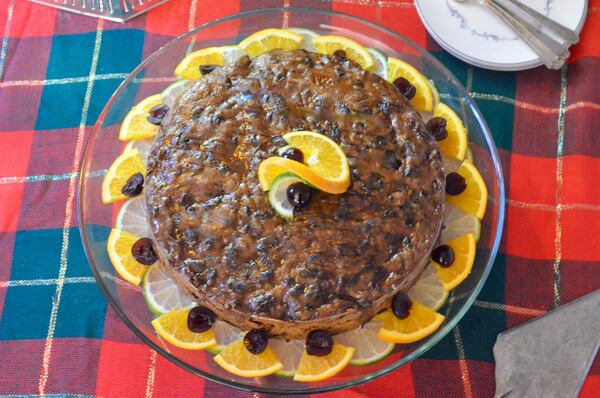 Caribbean black cake is intensely flavored with warm spices and dark in color from a melange of alcohol-soaked fruit. (Virginia Willis for The Atlanta Journal-Constitution)