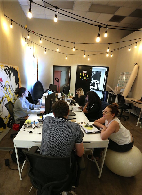 Sarah Biggers, founder of Clove + Hallow, sits with employees in the main office at the company headquarters in Atlanta. Clockwise from left are Colleen Drago, Viktoria Burak, Kesha Smith, Biggers and Tucker Stewart. CURTIS COMPTON / CCOMPTON@AJC.COM